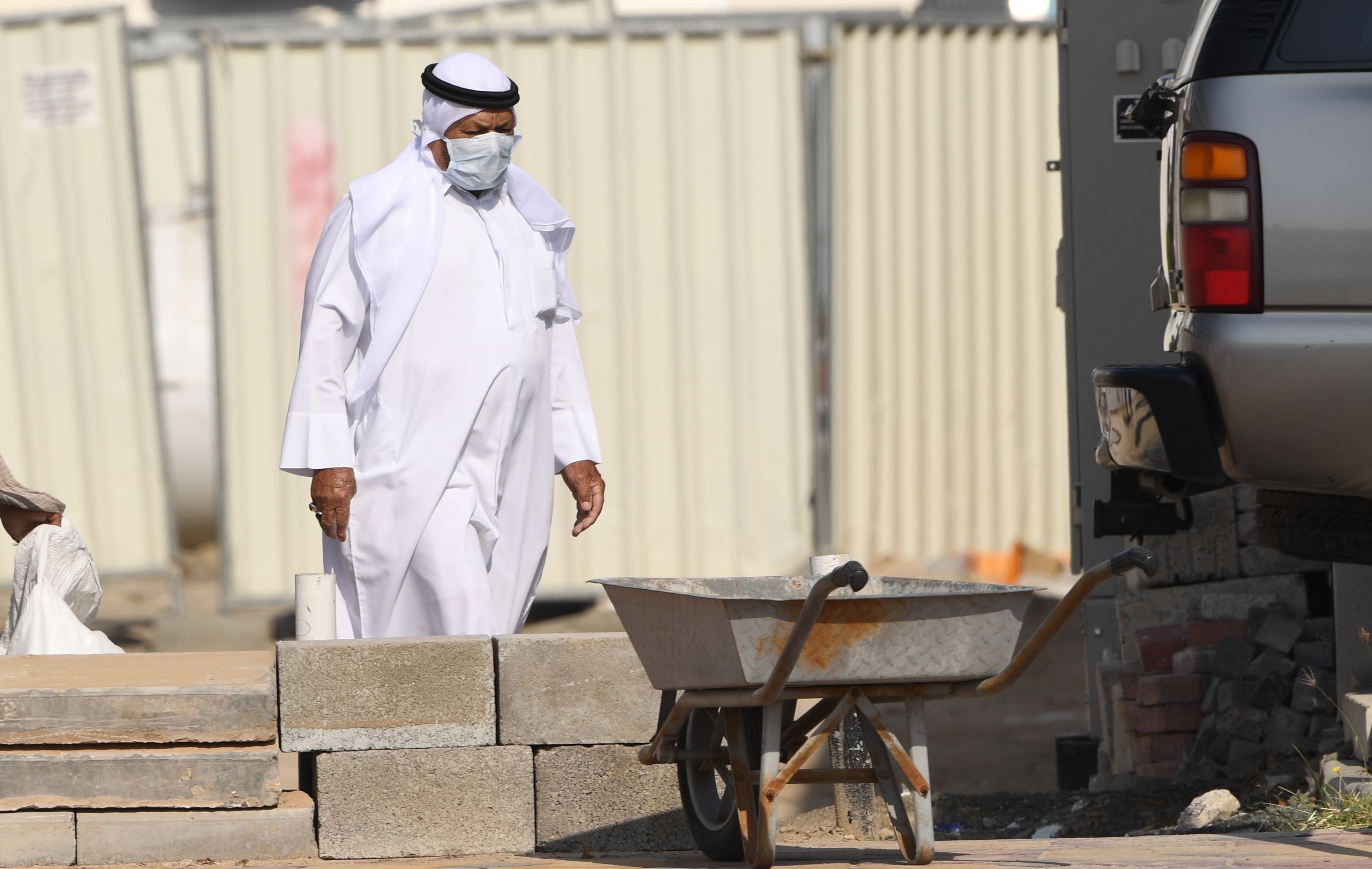 An Emirati man wearing a protective mask walks outside his house in Dubai. (Credit: AFP)