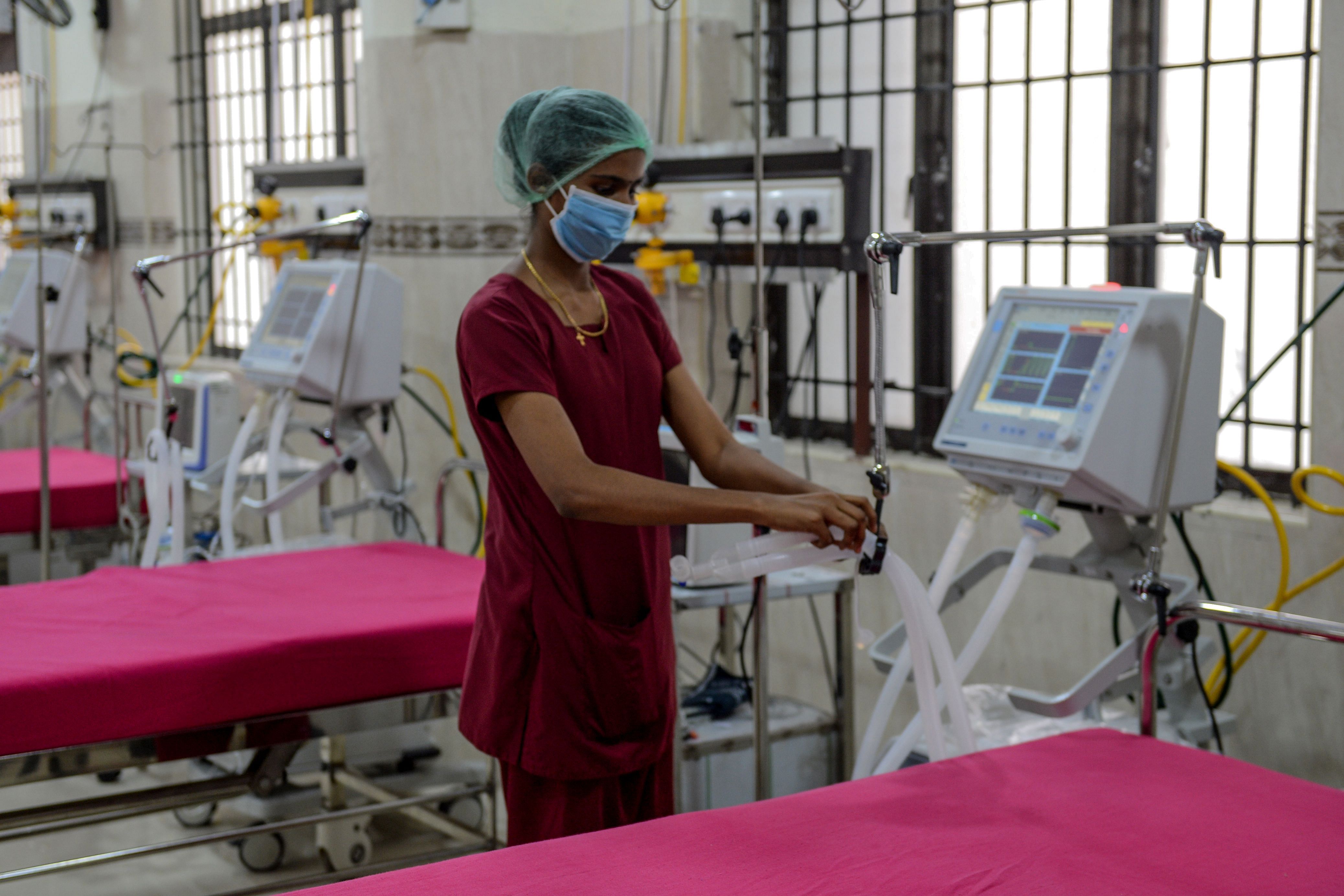 A medical staff checks on a ventilator of an intensive care unit at a newly inaugurated hospital by the Tamil Nadu