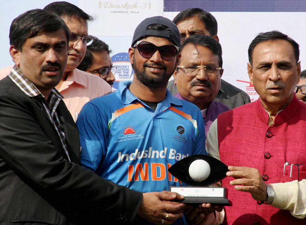 Gujarat Chief Minister Vijay Rupani awarding man of the match to Indian blind cricketer Prakash at Blind Cricket Tournament 2nd T20 World Cup 2017, at Sardar Patel Stadium Navarangpura in Ahmedabad on Saturday. PTI Photo