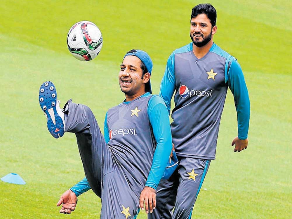 Relaxed Pakistan skipper Sarfraz Ahmed (left) and Azhar Ali enjoy a game of football during training. AFP Photo