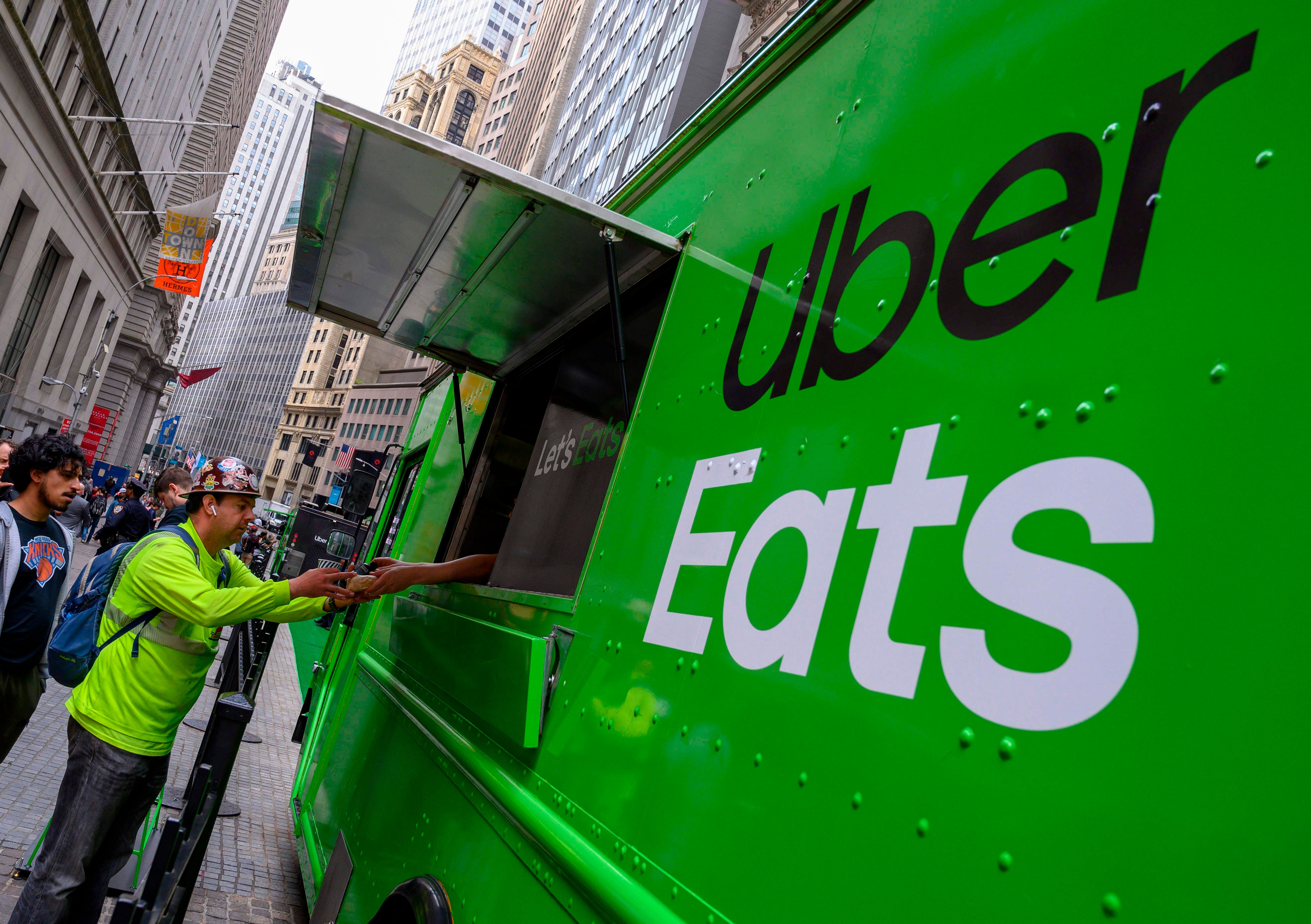 People buy food from an Uber Eats truck. (AFP Photo)