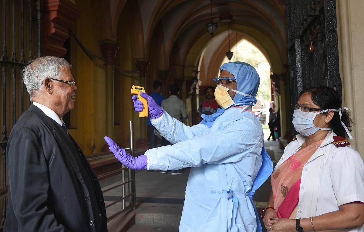 Thermal screening of lawyers being conducted in the wake of deadly coronavirus, at the entrance gate of Calcutta High Court in Kolkata, Tuesday, March 17, 2020. (PTI Photo)