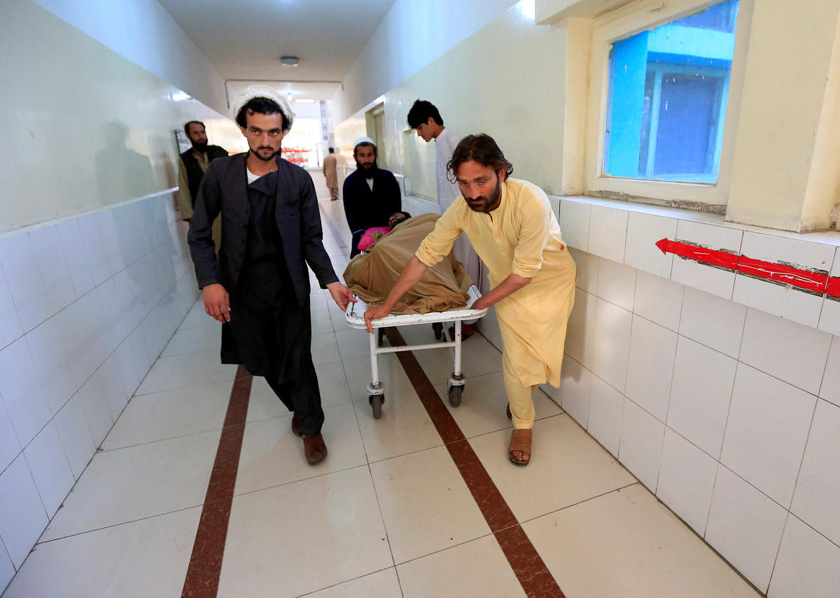 An injured man is transported on a stretcher in a hospital, after blasts at sports stadium, in Jalalabad city, Afghanistan May 19, 2018. (REUTERS/Parwiz)