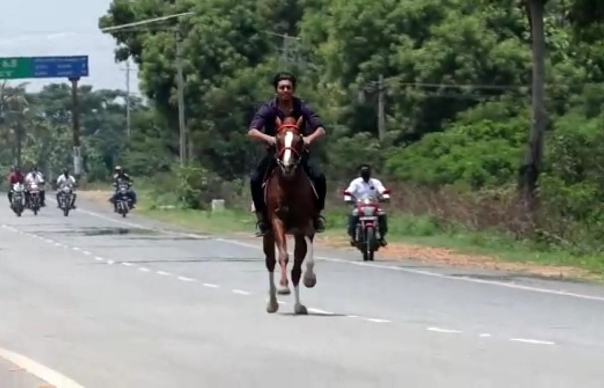 MLA C S Niranjan Kumar's son Bhuvan Kumar riding a horse on the national highway.