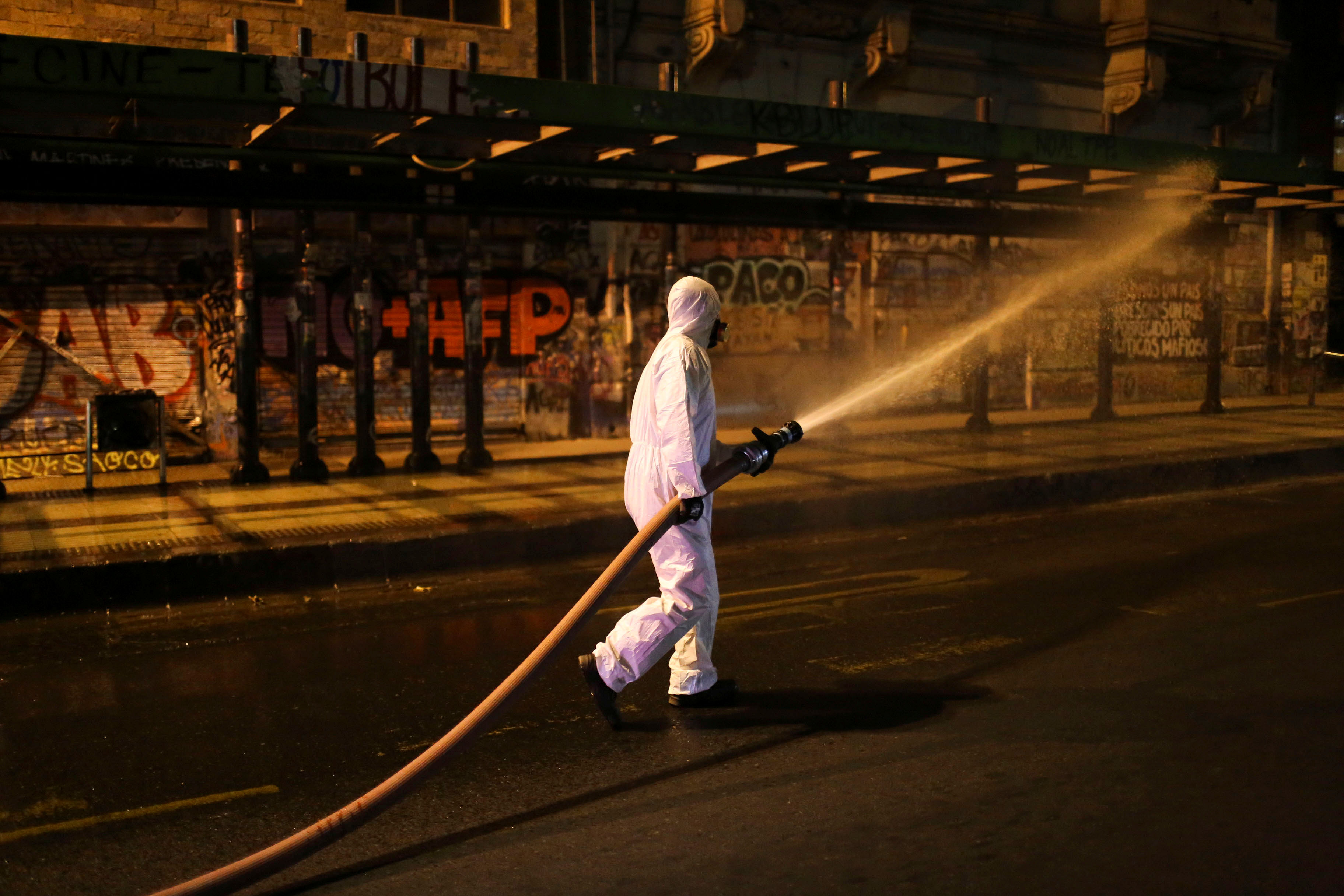 Local workers clean the streets as a precautionary measure, amid the coronavirus disease. (Credit: Reuters)