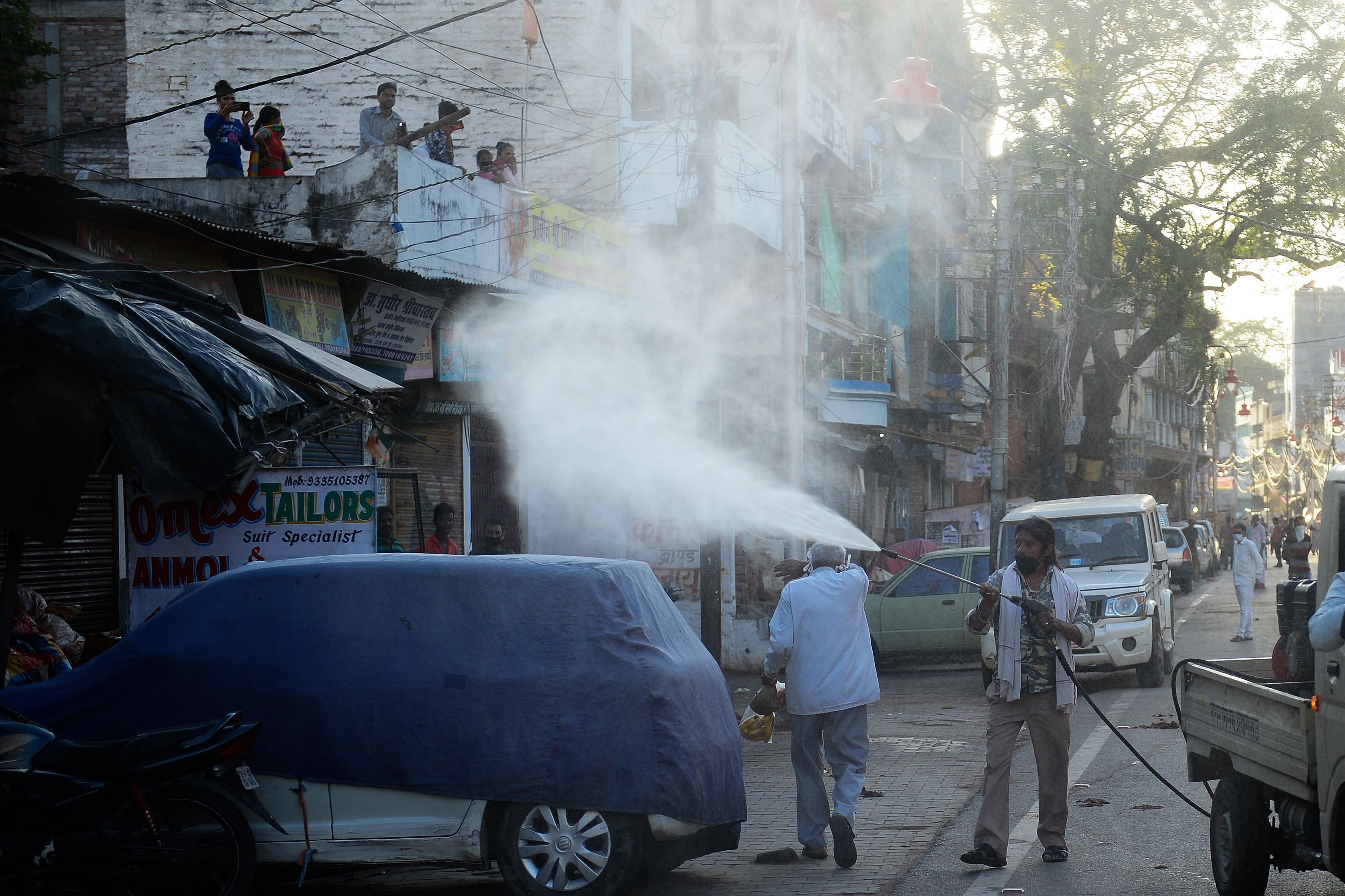 A municipal worker sprays disinfectant in UP. (Credit: AFP)