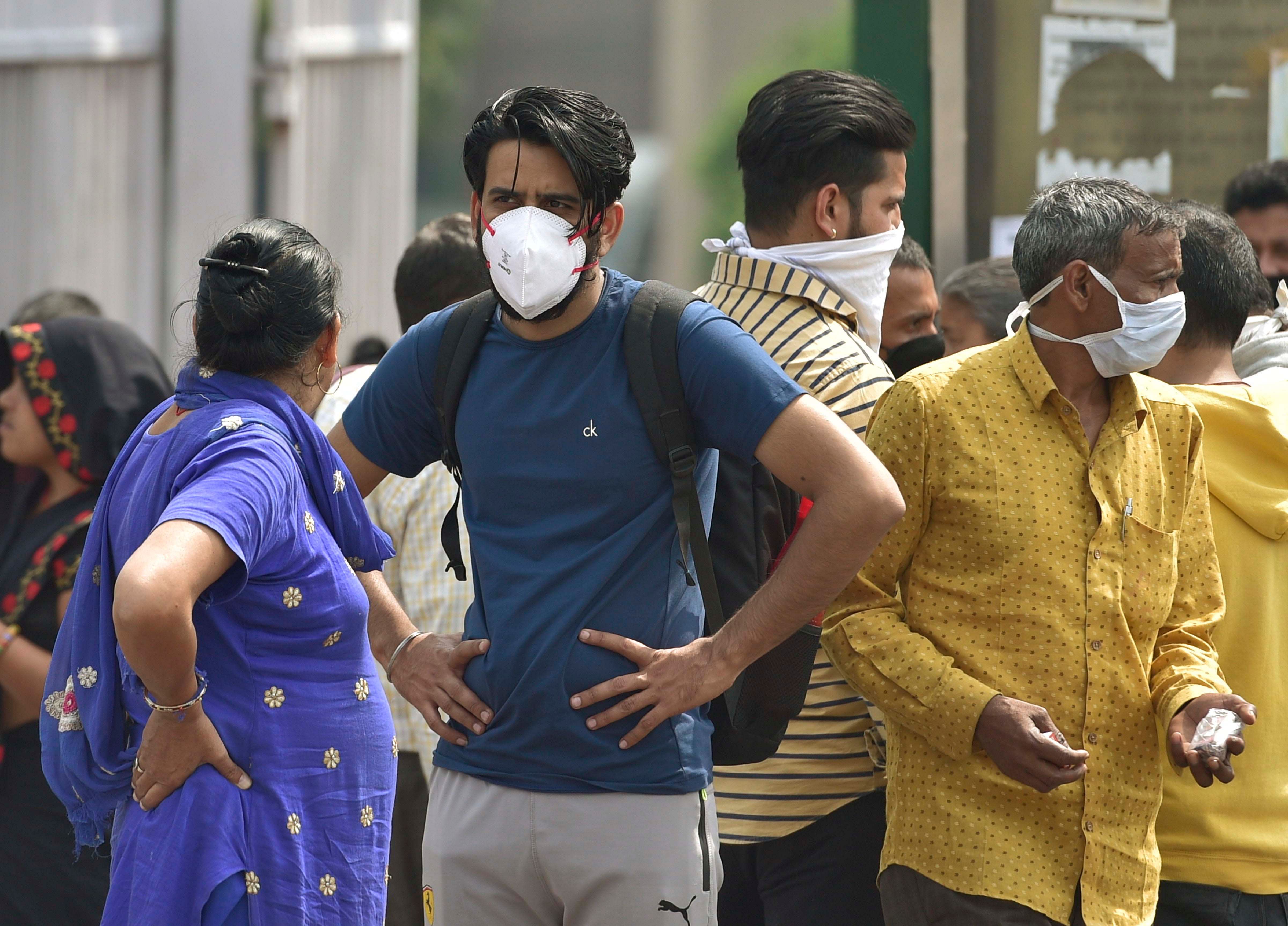 People wear protective masks as precaution against coronavirus, outside AIIMS hospital in New Delhi. (Credit: PTI)