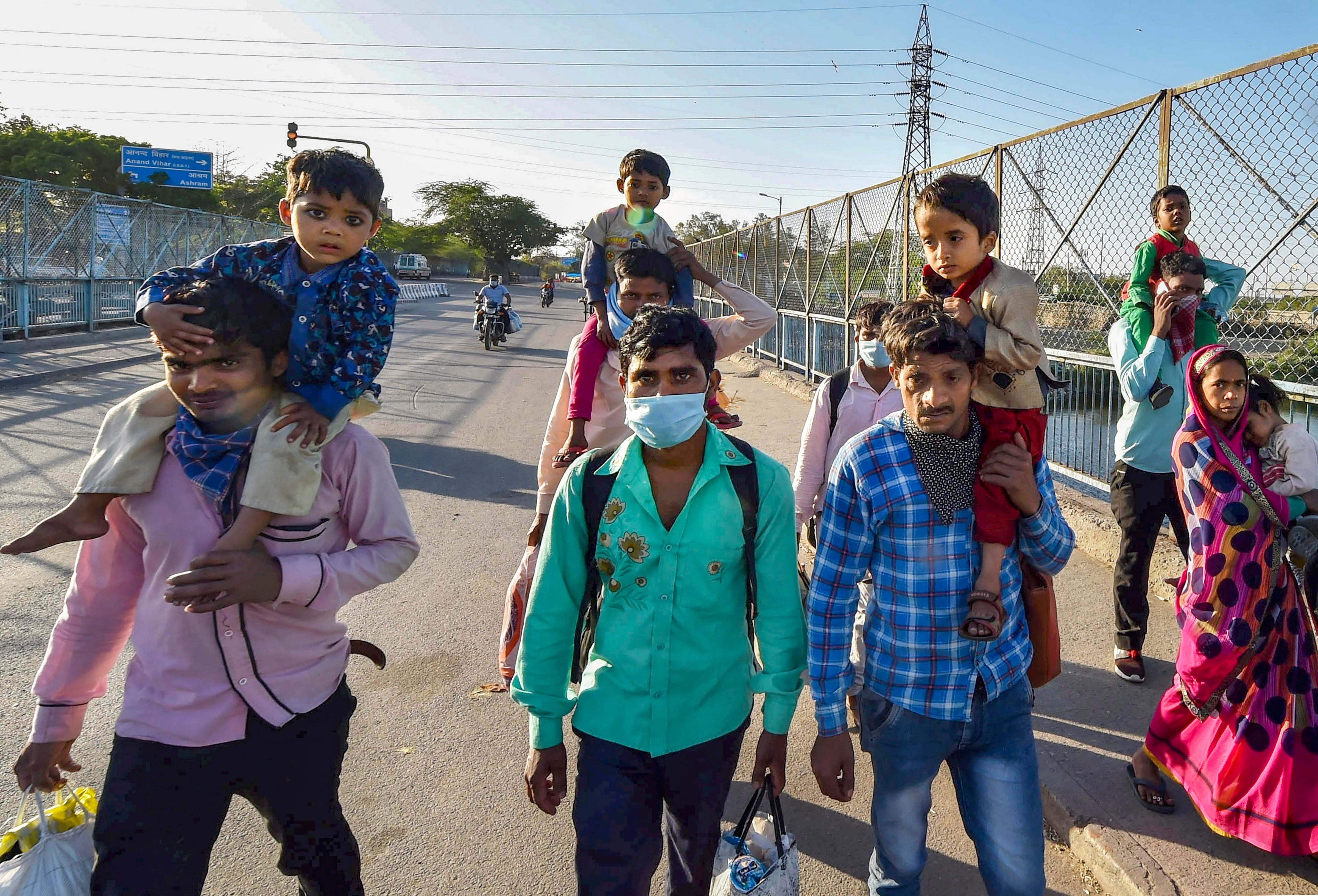 Migrant workers with their family members walks to their native village during a nationwide lockdown. (PTI Photo)
