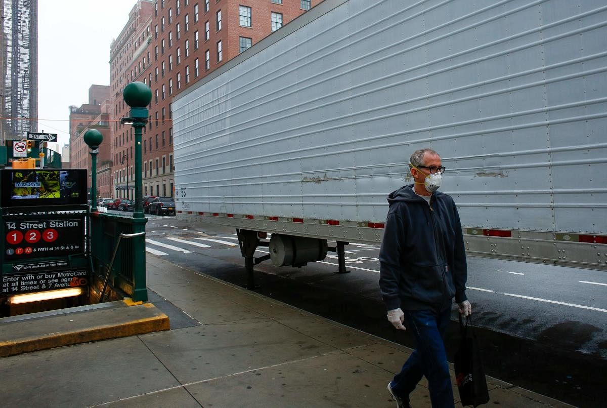 A man walks by a makeshift morgue set outside Lenox Health Medical Pavilion in New York City. AFP
