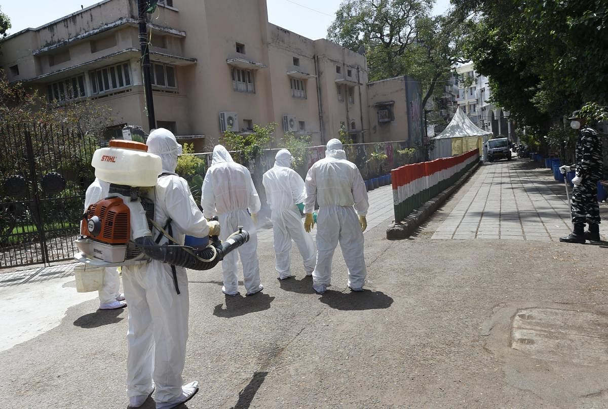  Health workers sanitise their collegues after disinfecting an area (PTI Photo)