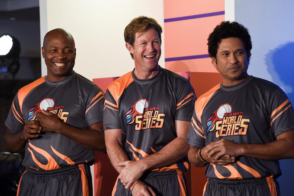(From left) Former cricketers Brian Lara, Jonty Rhodes and Sachin Tendulkar share a light moment during a promotional event in Mumbai on Thursday. AFP