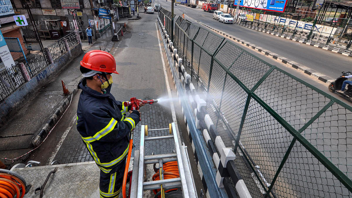 An emergency services worker in Assam sprays disinfectants to combat Covid-19.