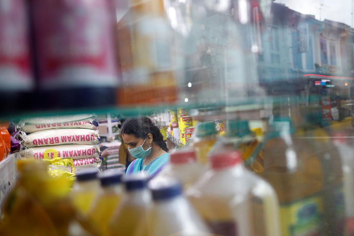 A woman wears a face mask at a shop in Little India district, as the spread of coronavirus disease (COVID-19) continues, in Singapore. (AFP Photo)