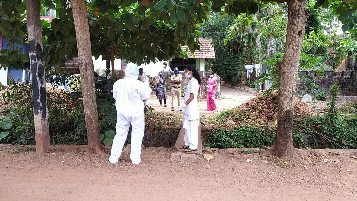 Members of Covid task force all set to shift a patient infected with Covid-19 to District Wenlock Hospital in Mangaluru in 108 ambulance before sealing Pilar in Someshwara on Wednesday.