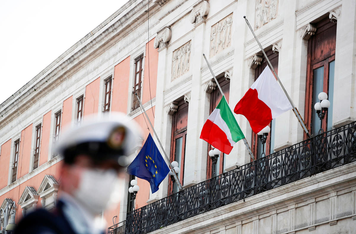 The flags of Italy, the European Union and Bari flutter to half mast to honour the country's dead due to coronavirus disease (COVID-19), in Bari, Italy (Reuters Photo)