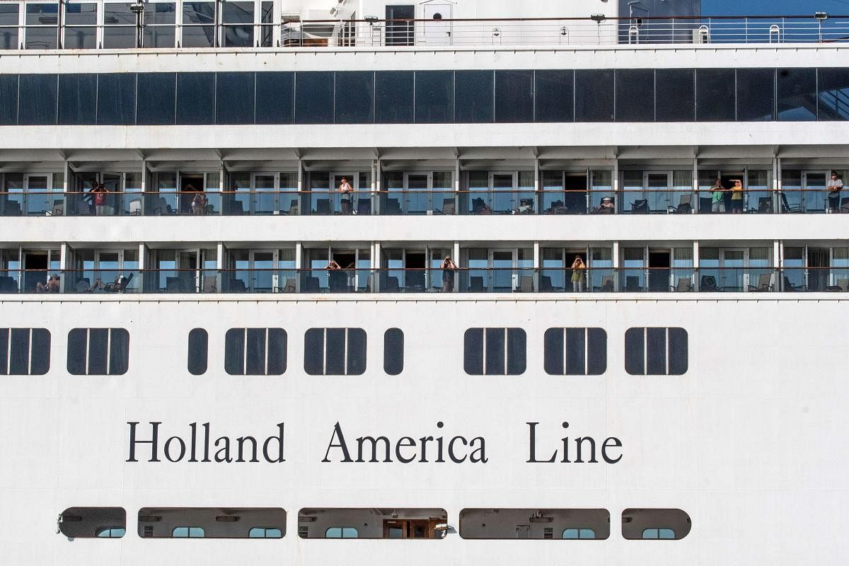 Passengers are seen onboard Holland America's cruise ship Zaandam as it entered the Panama City bay to be assisted by the Rotterdam cruise ship with supplies, personnel and COVID-19 testing devices, eight milles off the coast of Panama City, on March 27, 2020