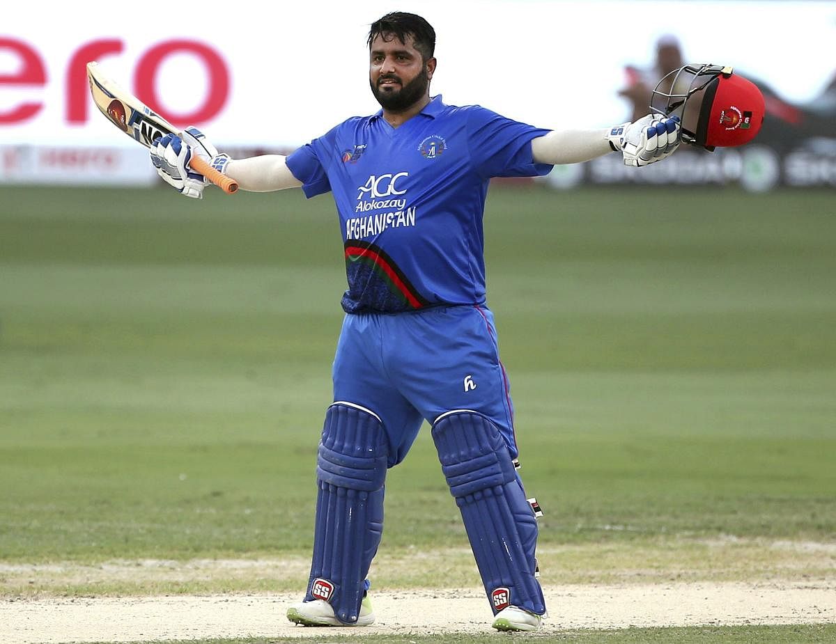 File photo of  Mohammad Shahzad celebrating his century in an ODI of Asia Cup 2018 against India. Photo credit: PTI