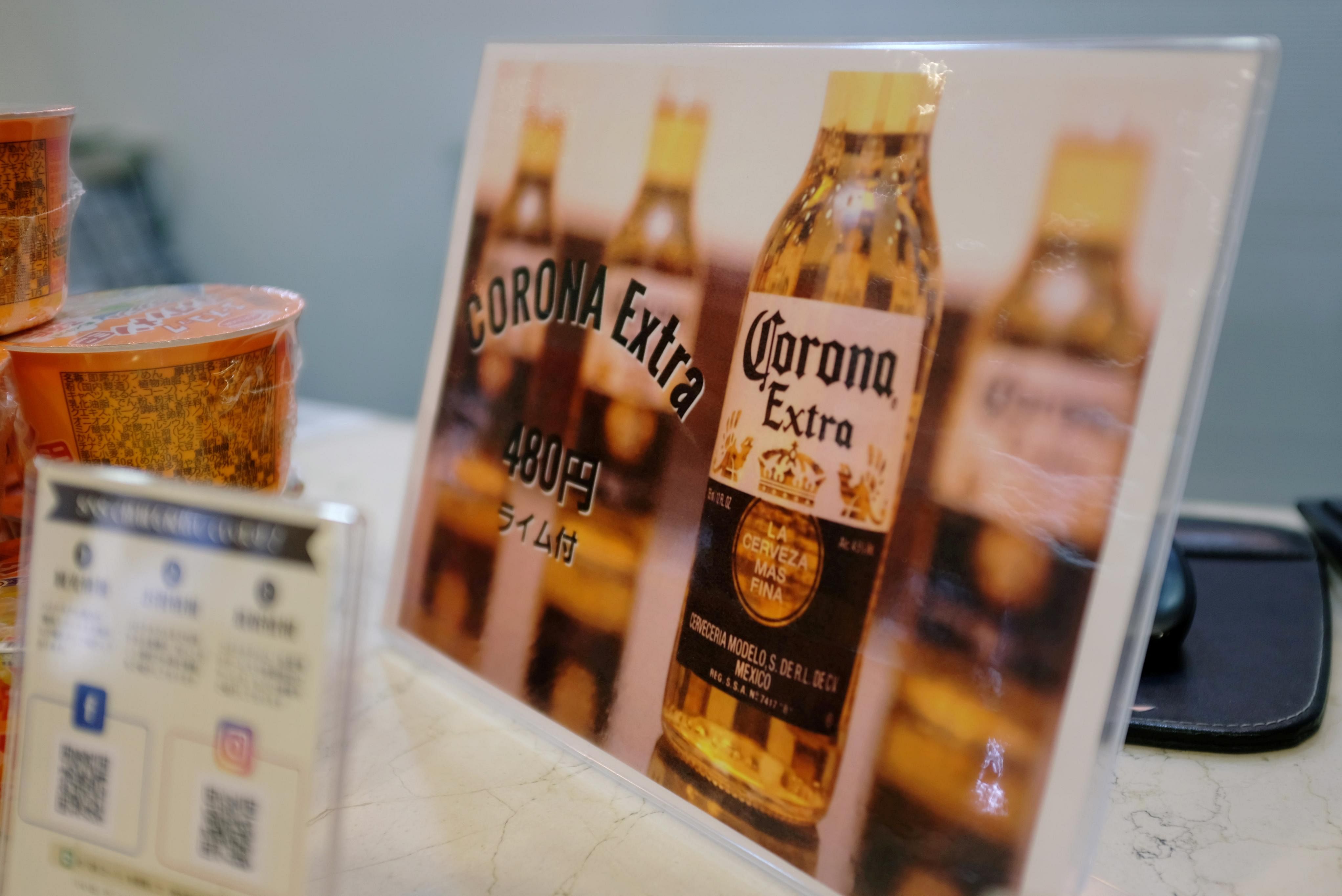 A sign advertising discounted Corona beers is displayed at the front desk of the Osaka Corona Hotel in Osaka, Japan. (Credit: Reuters)