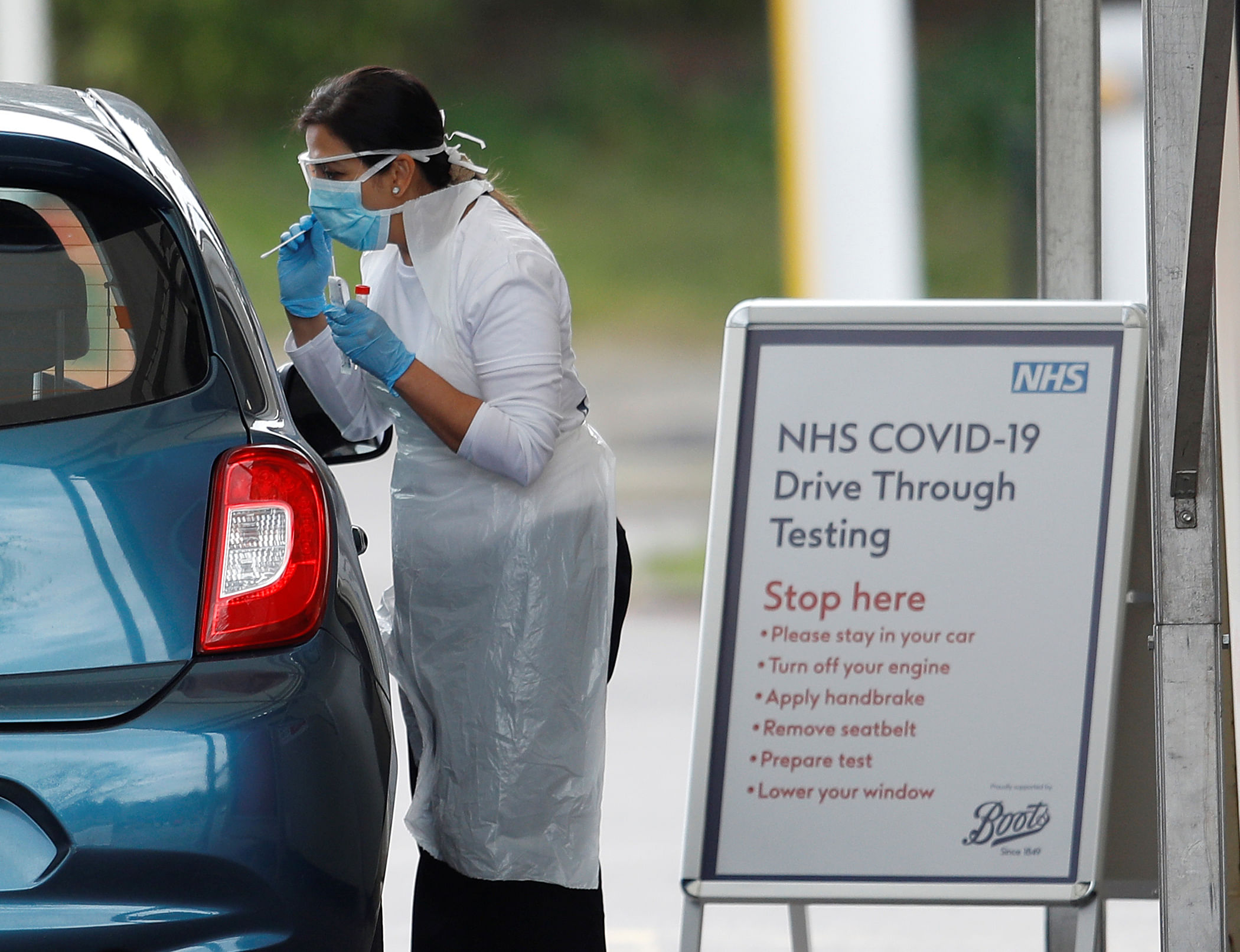 Medical staff at an NHS drive through coronavirus disease (COVID-19) testing facility in the car park of Chessington World of Adventures, as the spread of the coronavirus disease (COVID-19) continues. (Credit: Reuters)