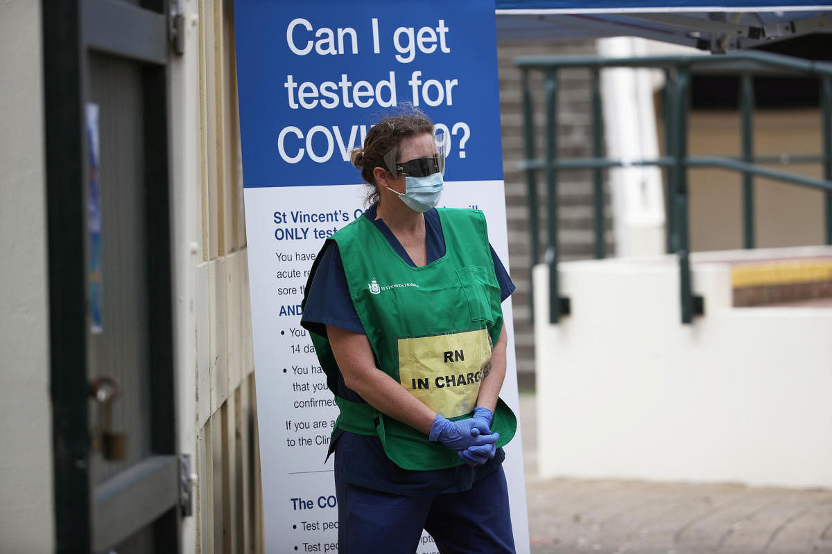 A healthcare professional waits at a pop-up clinic testing for the coronavirus disease (COVID-19) in Australia (Reuters Photo)