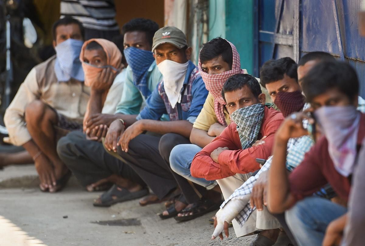 Stranded migrant workers wait for packaged food, distributed by Central Reserve Police Force (CRPF), during the nationwide lockdown in the wake of coronavirus pandemic, in Chennai, Wednesday, April 1, 2020. (PTI Photo)