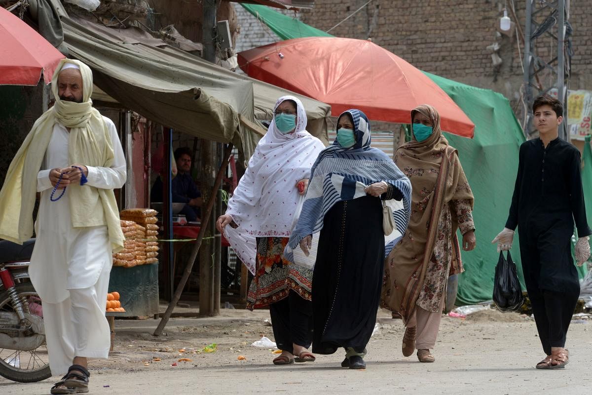 Women wearing facemasks walk on a street during a government-imposed nationwide lockdown as a preventive measure against the COVID-19 coronavirus, in Peshawar on April 6, 2020 Credit: AFP Photo