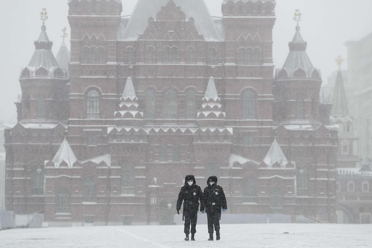 Police officers walk across an empty Red Square in Moscow, Russia, Tuesday, March 31, 2020. Credit: AFP Photo