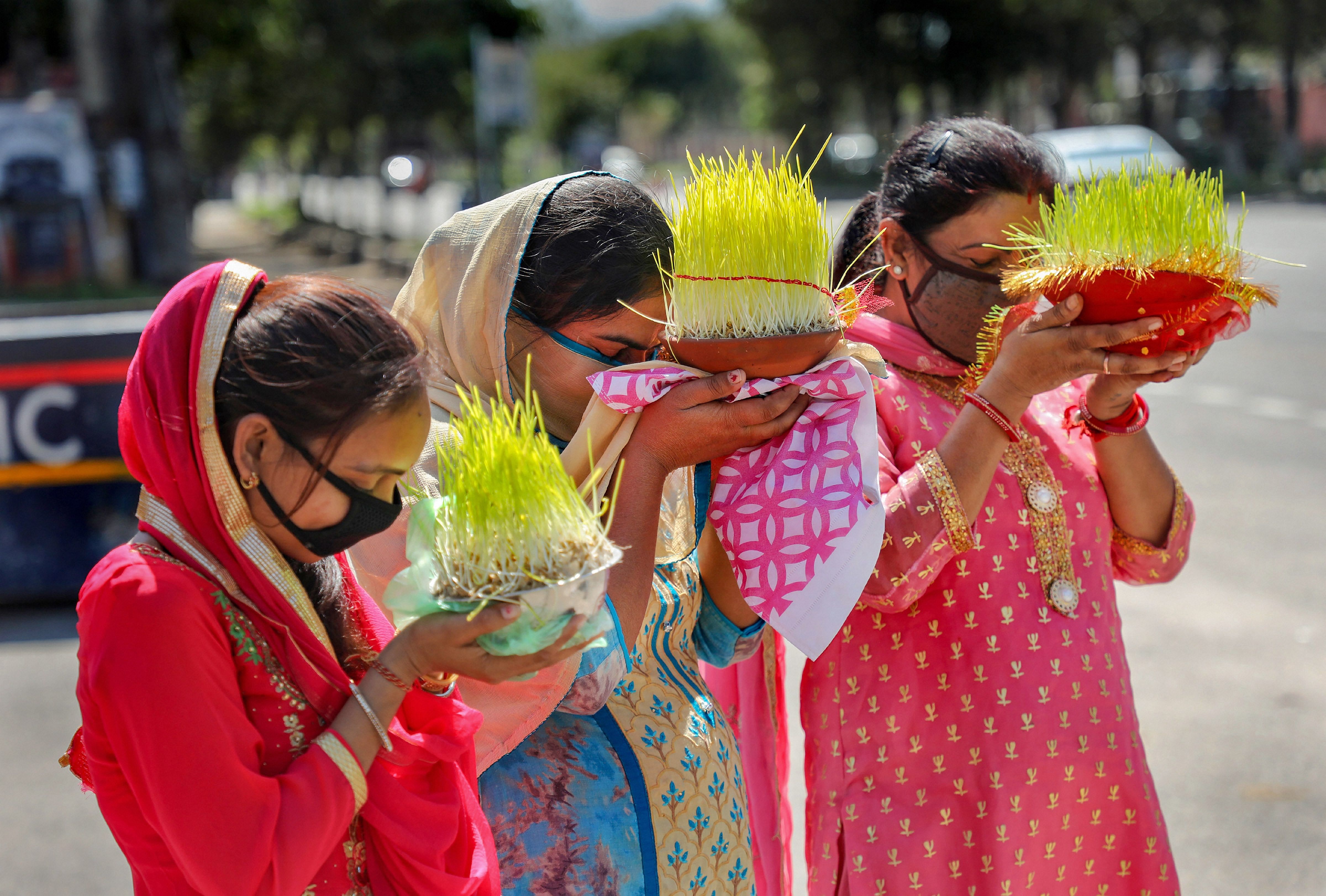 Devotees offer prayers while carrying 'Saakh', representing goddess Durga, on the occasion of Ashtami, during the nationwide lockdown in wake of coronavirus outbreak. (PTI Photo)