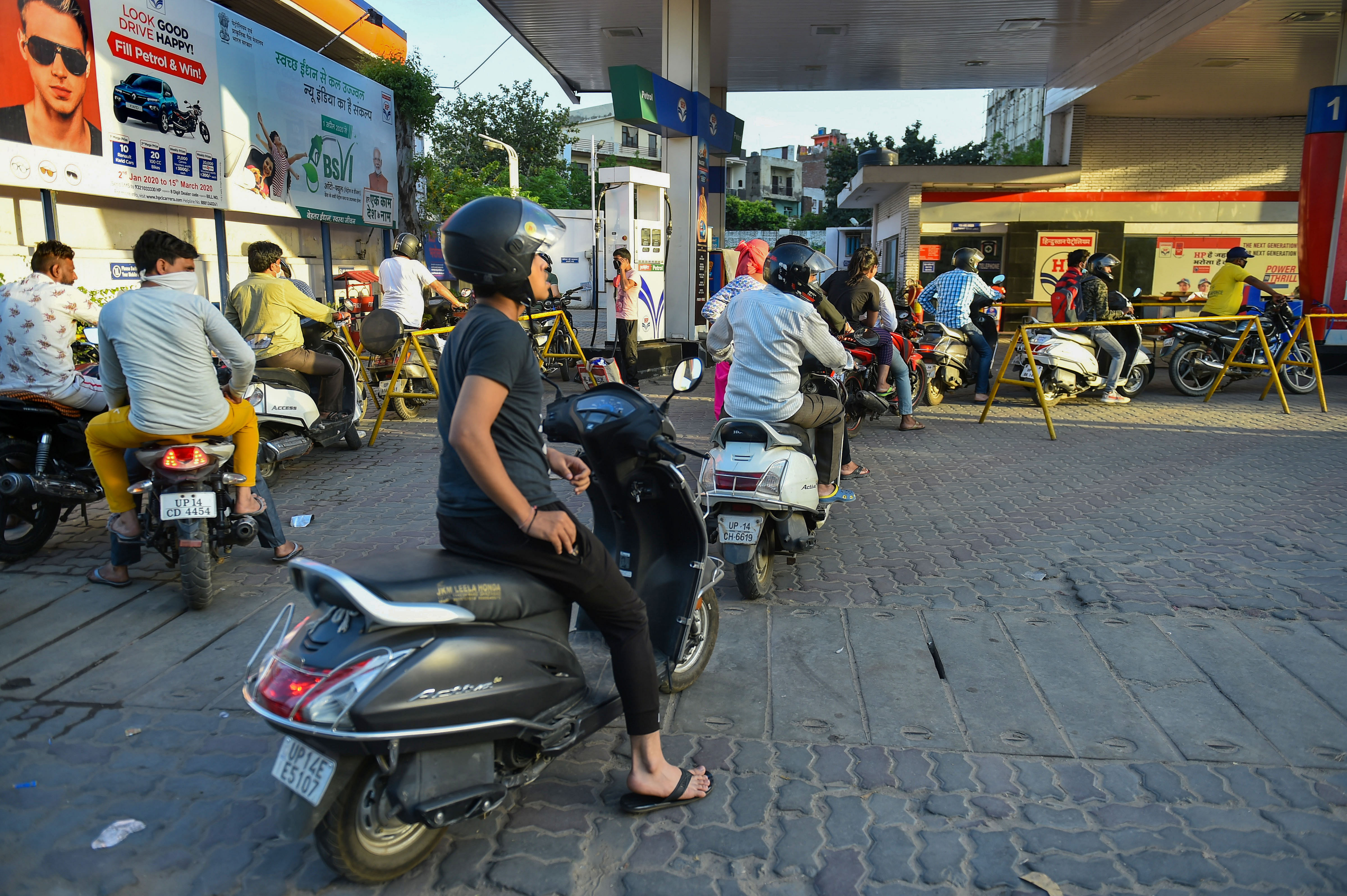Long queue of vehicles is seen at a fuel station, after the Uttar Pradesh government ordered a complete shutdown of COVID-19 hotpots in 15 districts till April 15. (PTI Photo)