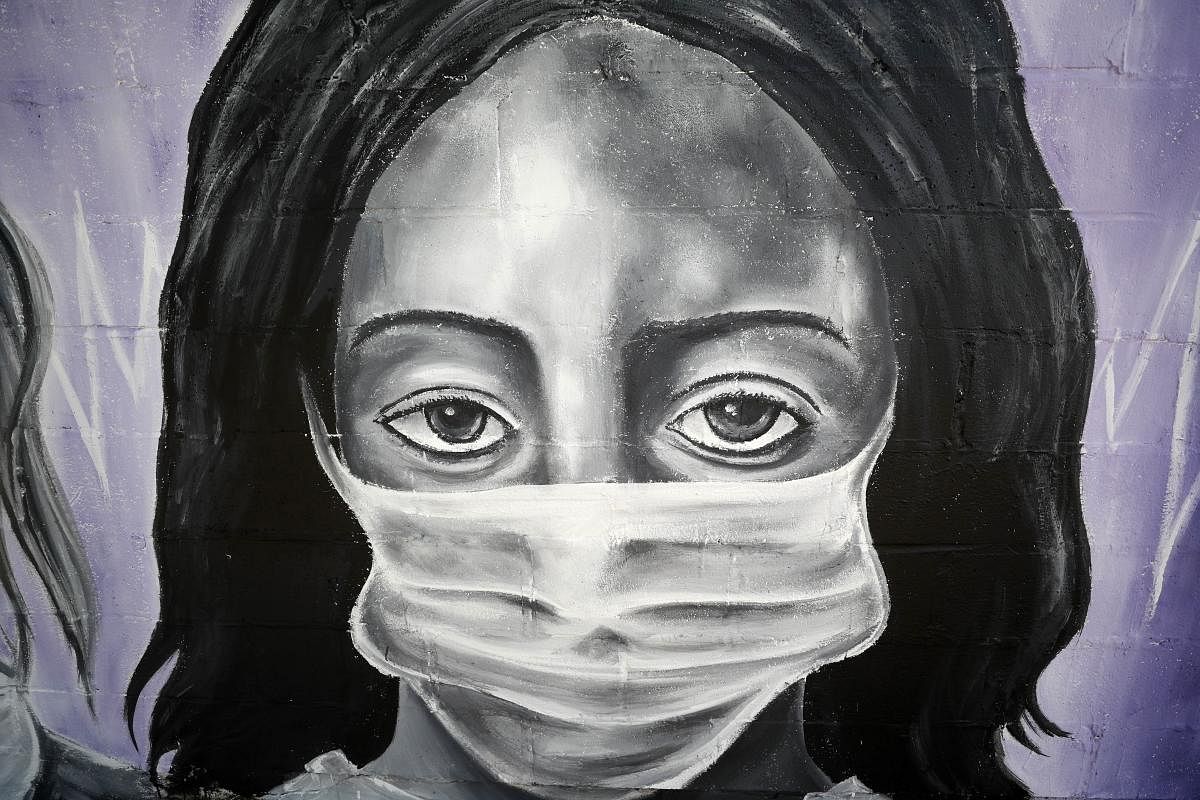 A painting by the graffiti artist Bandit titled Our Nurses, Our Saints is seen on a wall in the lower ninth ward on April 03, 2020 in New Orleans, Louisiana. Credit: AFP Photo