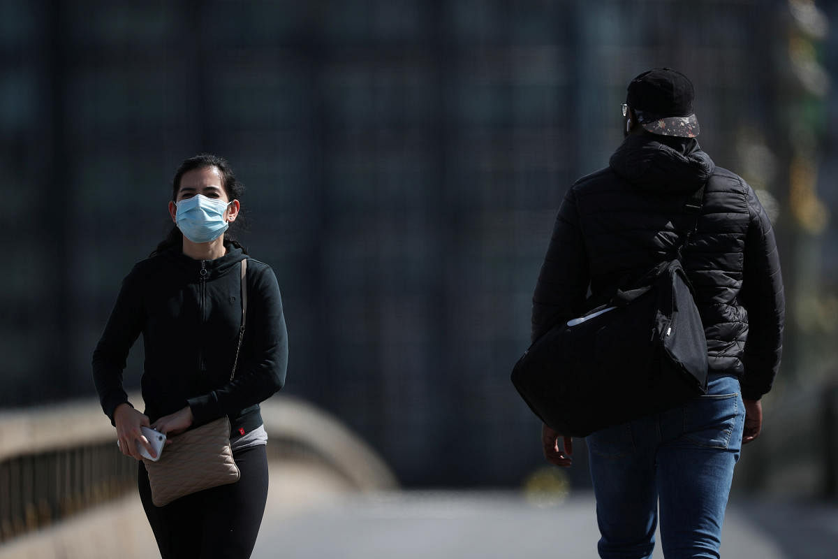 A woman wearing a protective face mask is seen on Westminster Bridge, as the spread of the coronavirus disease (COVID-19) continues, London, Britain, April 6, 2020.  Credit: Reuters Photo
