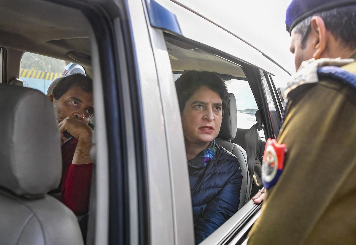 A police officer stops Congress leaders Rahul Gandhi (R) and Priyanka Gandhi Vadra from entering Meerut city, at the border of Meerut, Tuesday, Dec. 24, 2019. (PTI Photo)