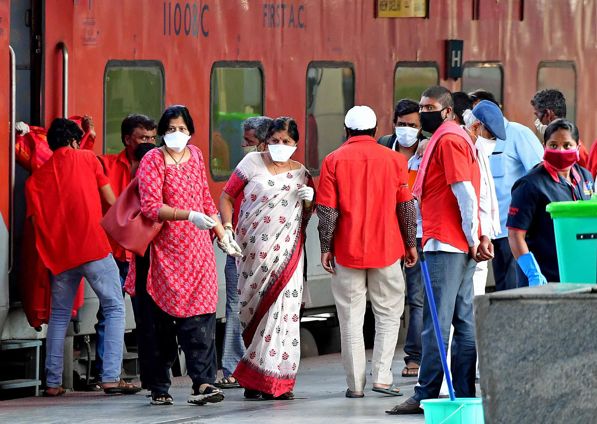 Passengers get down from the special train from New Delhi at KSR Railway Station in Bengaluru on Thursday. DH Photo