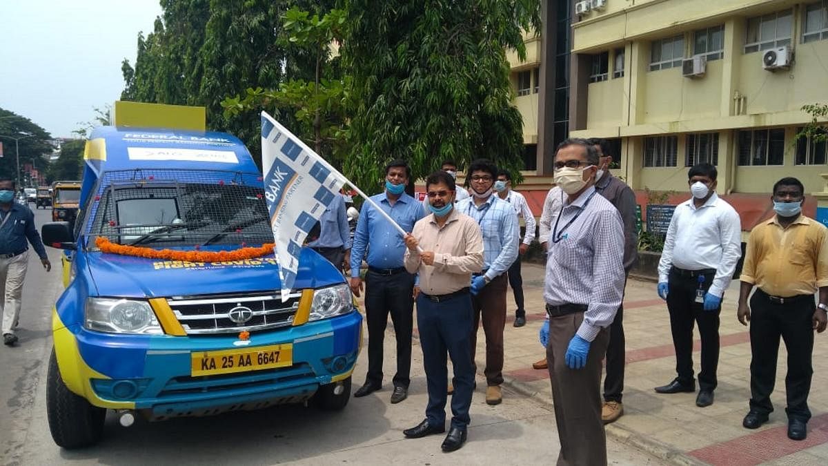 MCC Commissioner Ajith Kumar Hegde flags off mobile ATM services of Federal Bank in Mangaluru.