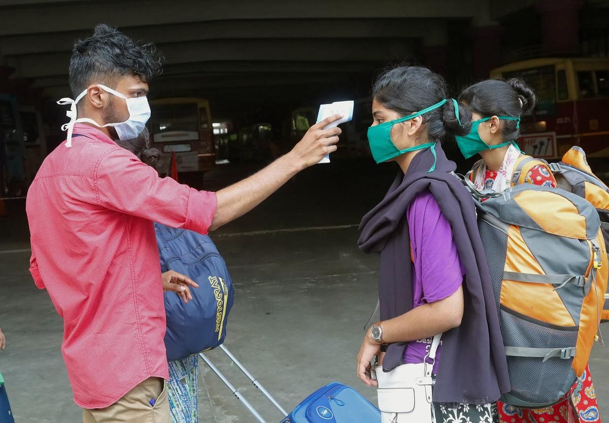 Thermal screening of passengers being conducted in the wake of deadly coronavirus, at a bus stand, in Kozhikode, Friday, March 20, 2020. (PTI Photo)