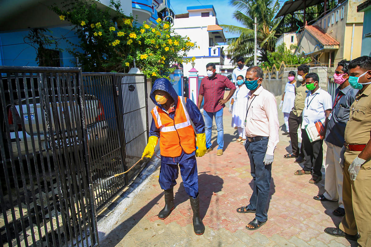 The house of a person, who attended the religious congregation at a mosque in Delhi's Nizamuddin area, being sanitised at Velladichivila near Nagercoil. PTI