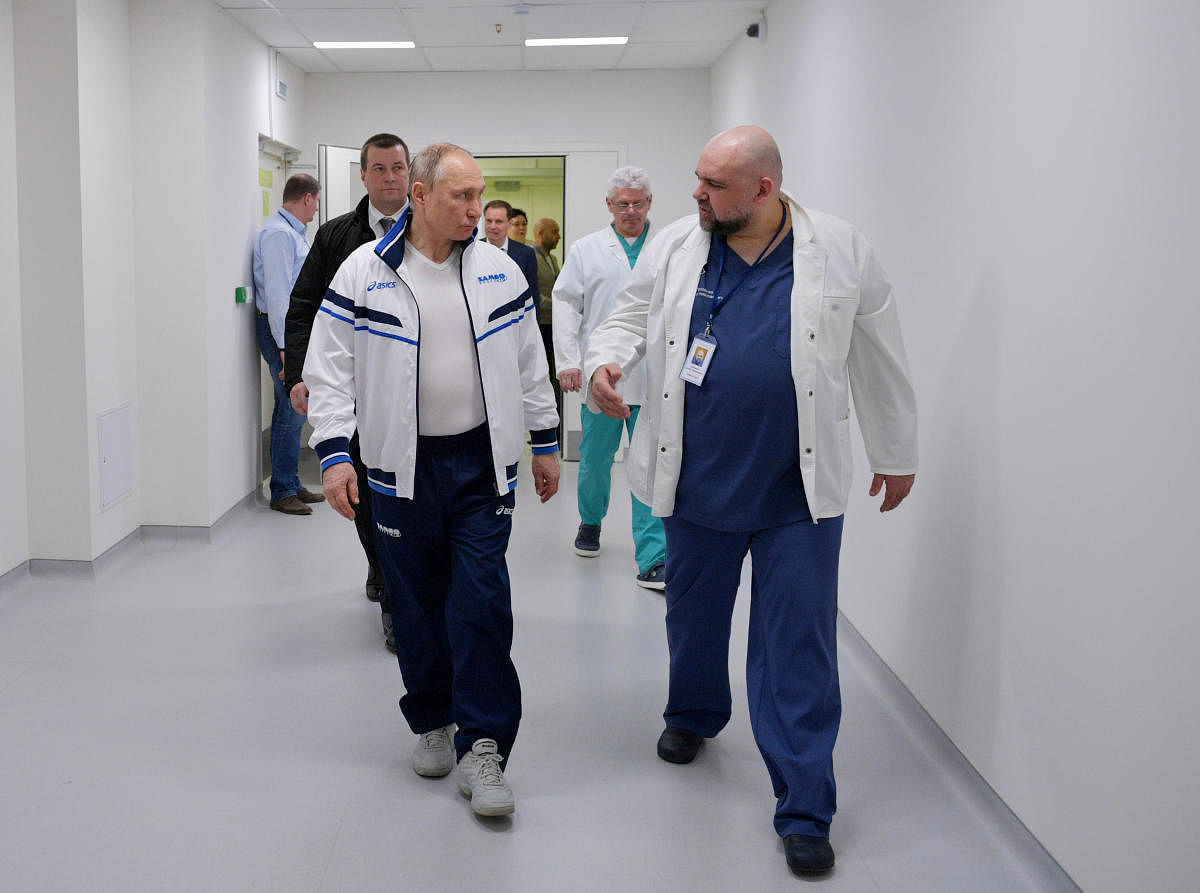 Putin listens to Denis Protsenko, chief physician of a hospital for patients infected with coronavirus disease (COVID-19), as they walk at the hospital, on the outskirts of Moscow (Reuters Photo)