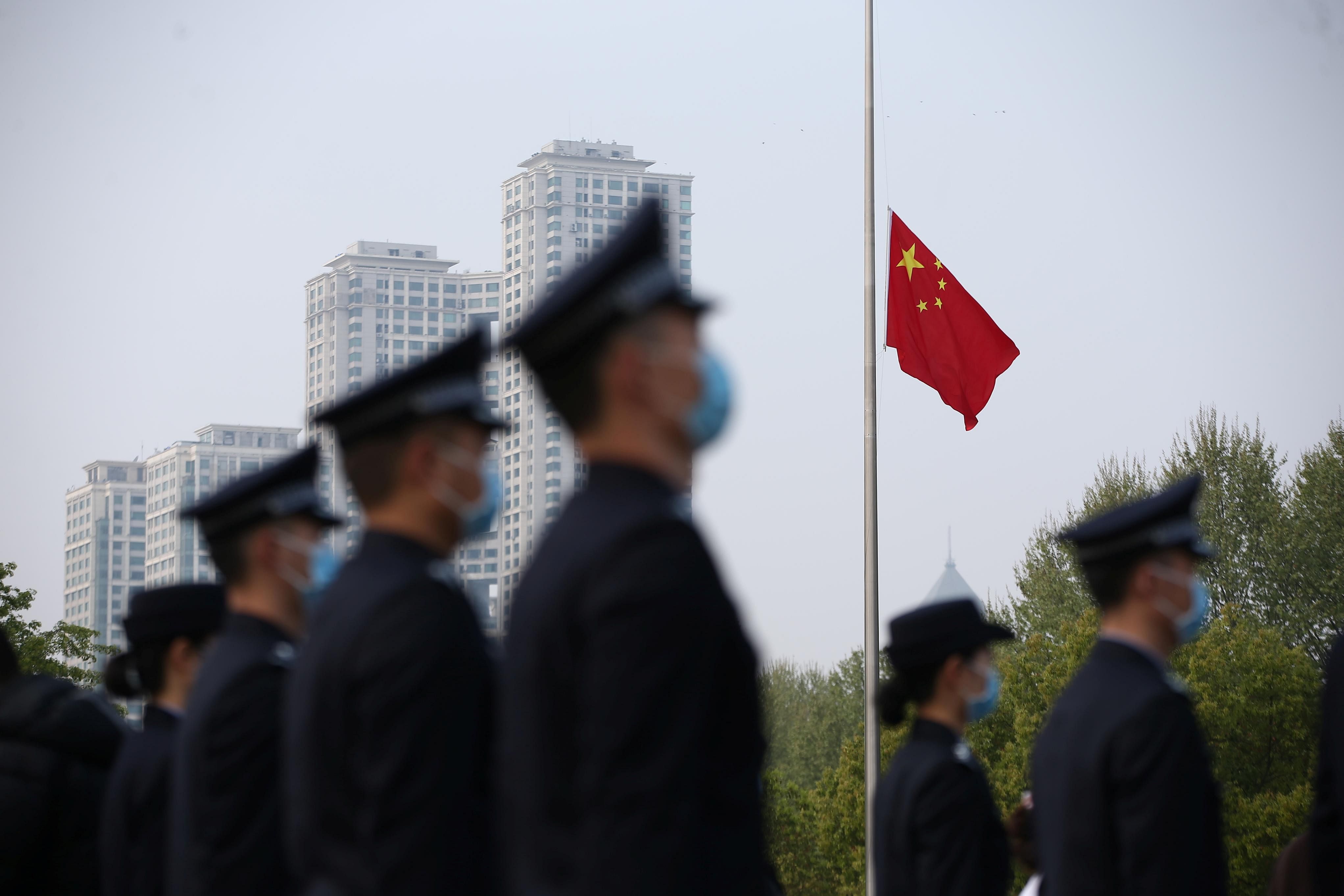 The Chinese national flag flies at half mast at a ceremony mourning those who died of the coronavirus disease (COVID-19) as China holds a nationwide mourning. (Credit: Reuters)