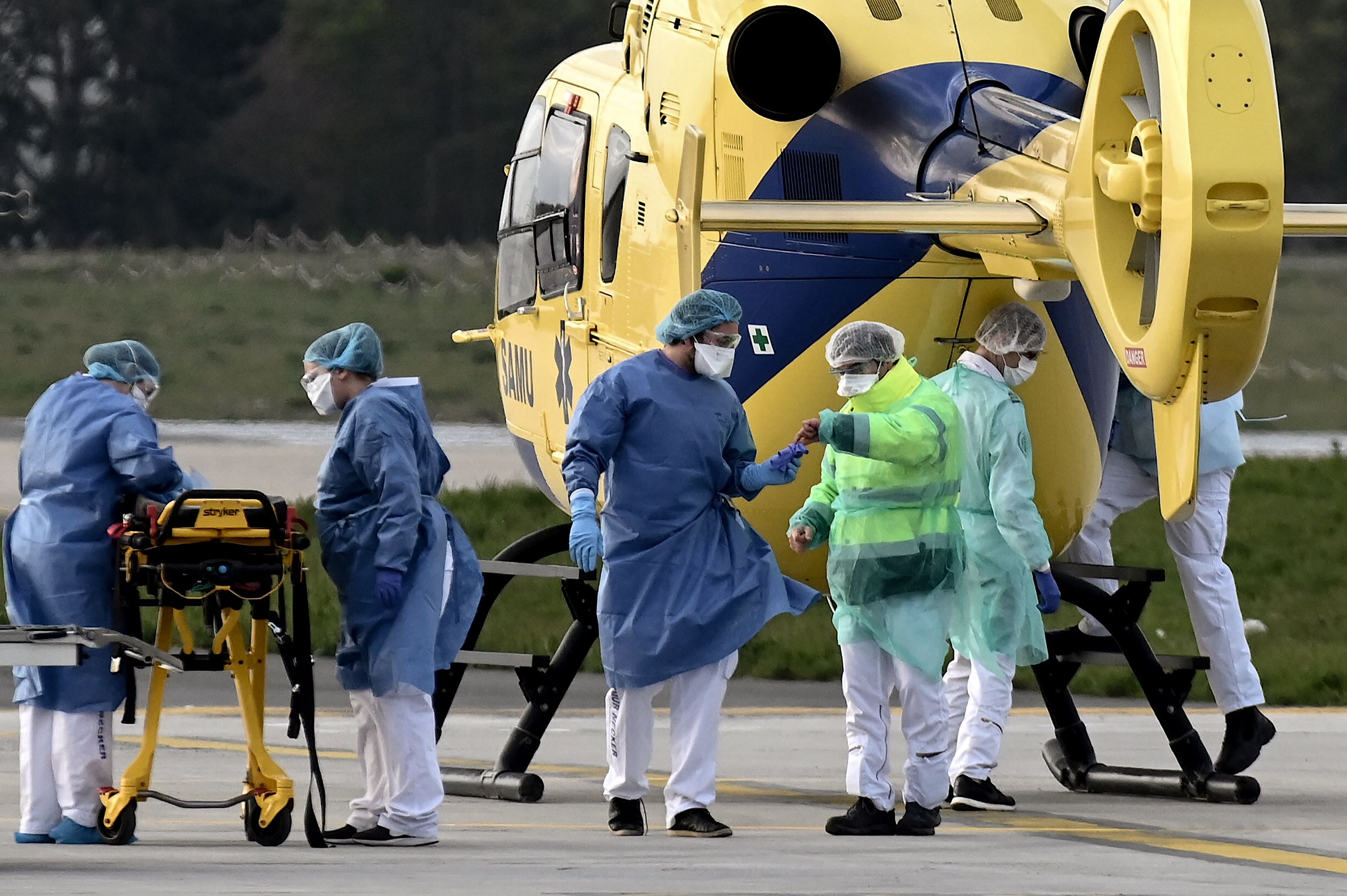 Medical staff members stand by a Eurocopter EC-135 after loading a patient in Paris. (Credit: AFP)
