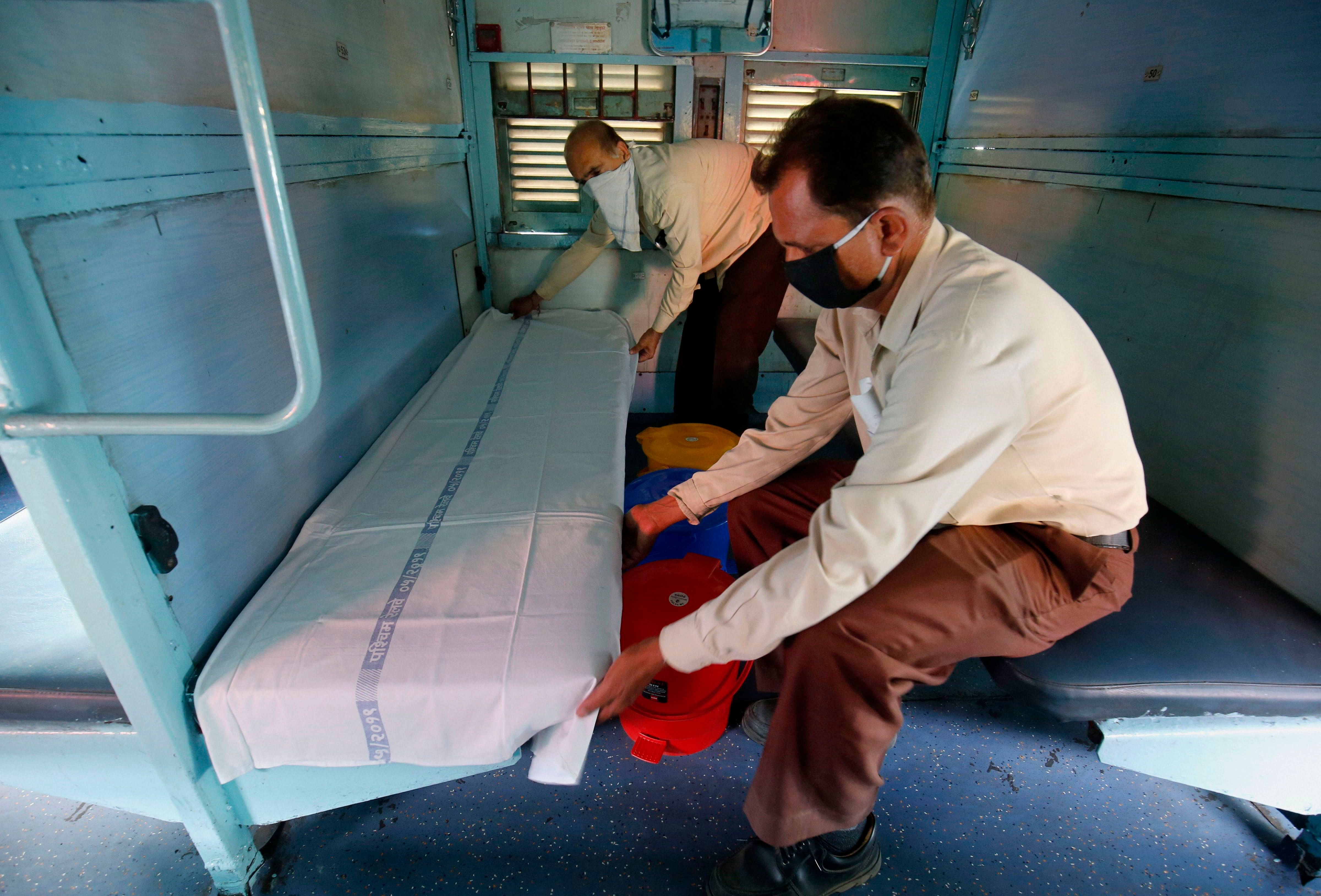 Workers prepare railway coaches to be converted into isolation wards for COVID-19 patients, during the nationwide lockdown. (PTI Photo)