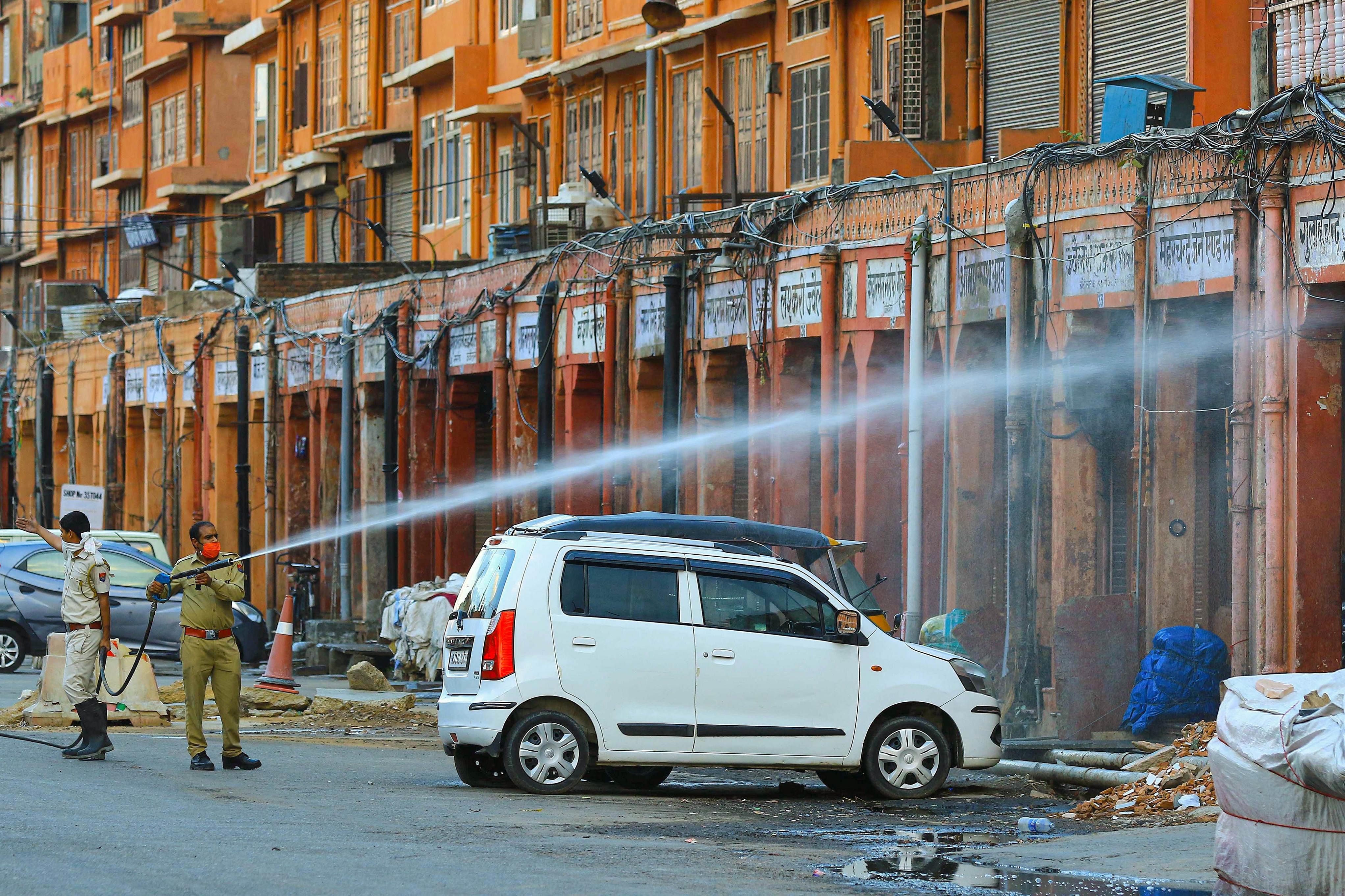 Jaipur: Fire station officials spray disinfectants amid concerns over the spread of the COVID-19 disease. (Credit: PTI)