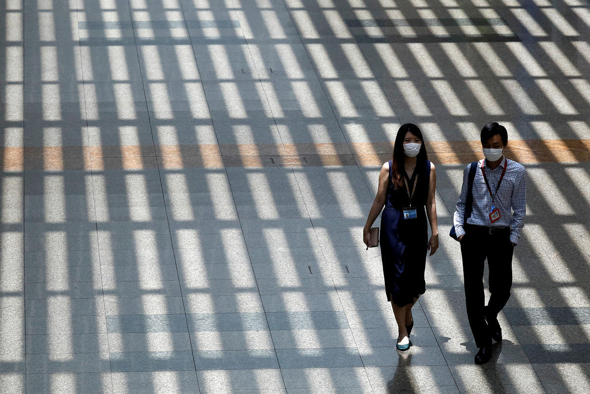 People wearing protective face masks walk at Singapore's Changi Airport, following the outbreak of the coronavirus disease (COVID-19) March 30, 2020. Credit: Reuters Photo