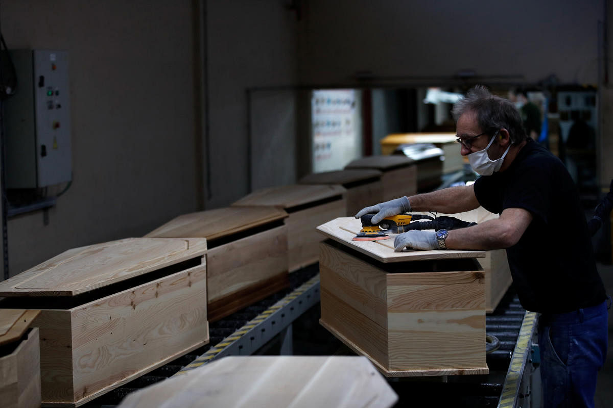 An employee works at the coffin manufacturing plant OGF in Jussey as the spread of the coronavirus (COVID-19) disease continues in France April 2, 2020. Credit: Reuters Photo