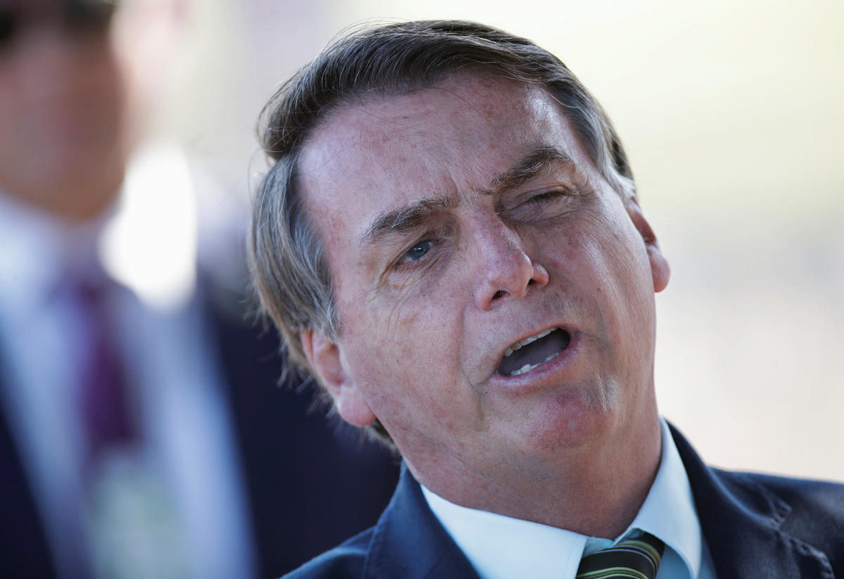 Brazil's President Jair Bolsonaro reacts after asked by journalists as he leaves at Alvorada Palace, amid coronavirus disease (COVID-19) outbreak, in Brasilia, Brazil (Reuters Photo)