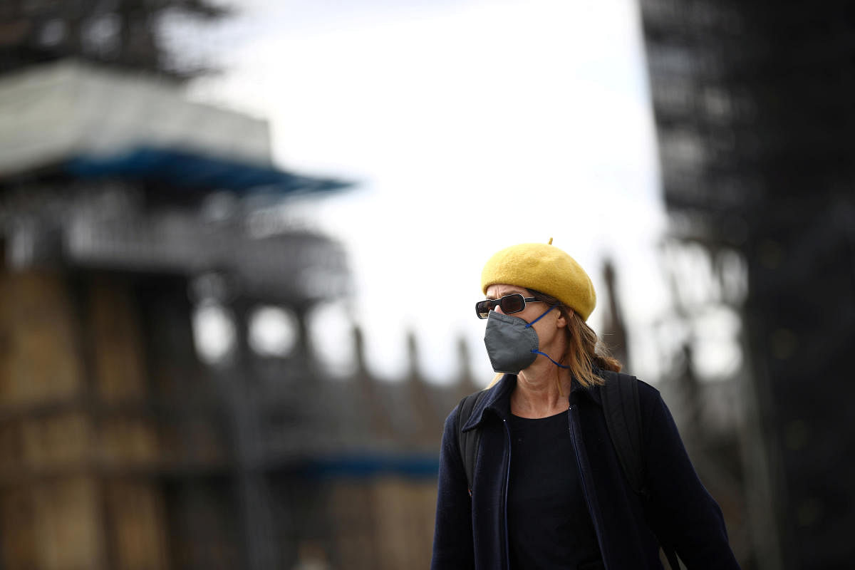 A woman wearing a protective face mask walks on Westminster Bridge, as the spread of the coronavirus disease (COVID-19) continues, London, Britain, April 3, 2020. REUTERS/Hannah McKay