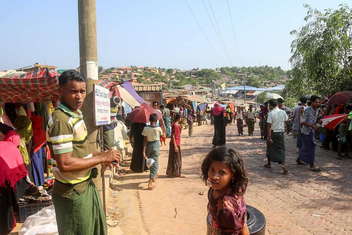 Rohingya refugees gather at a market as first cases of COVID-19 coronavirus have emerged in the area, in Kutupalong refugee camp in Ukhia. AFP