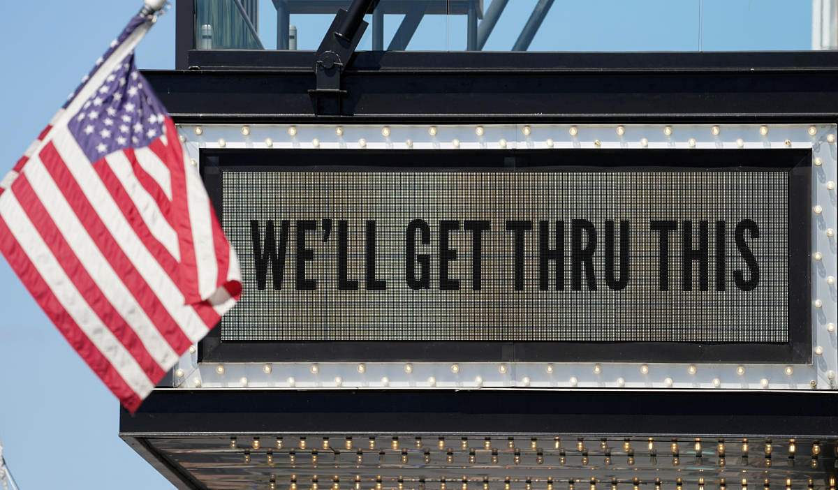 A flag flies beside a coronavirus marquee at a music venue in Washington. Credit: Reuters Photo