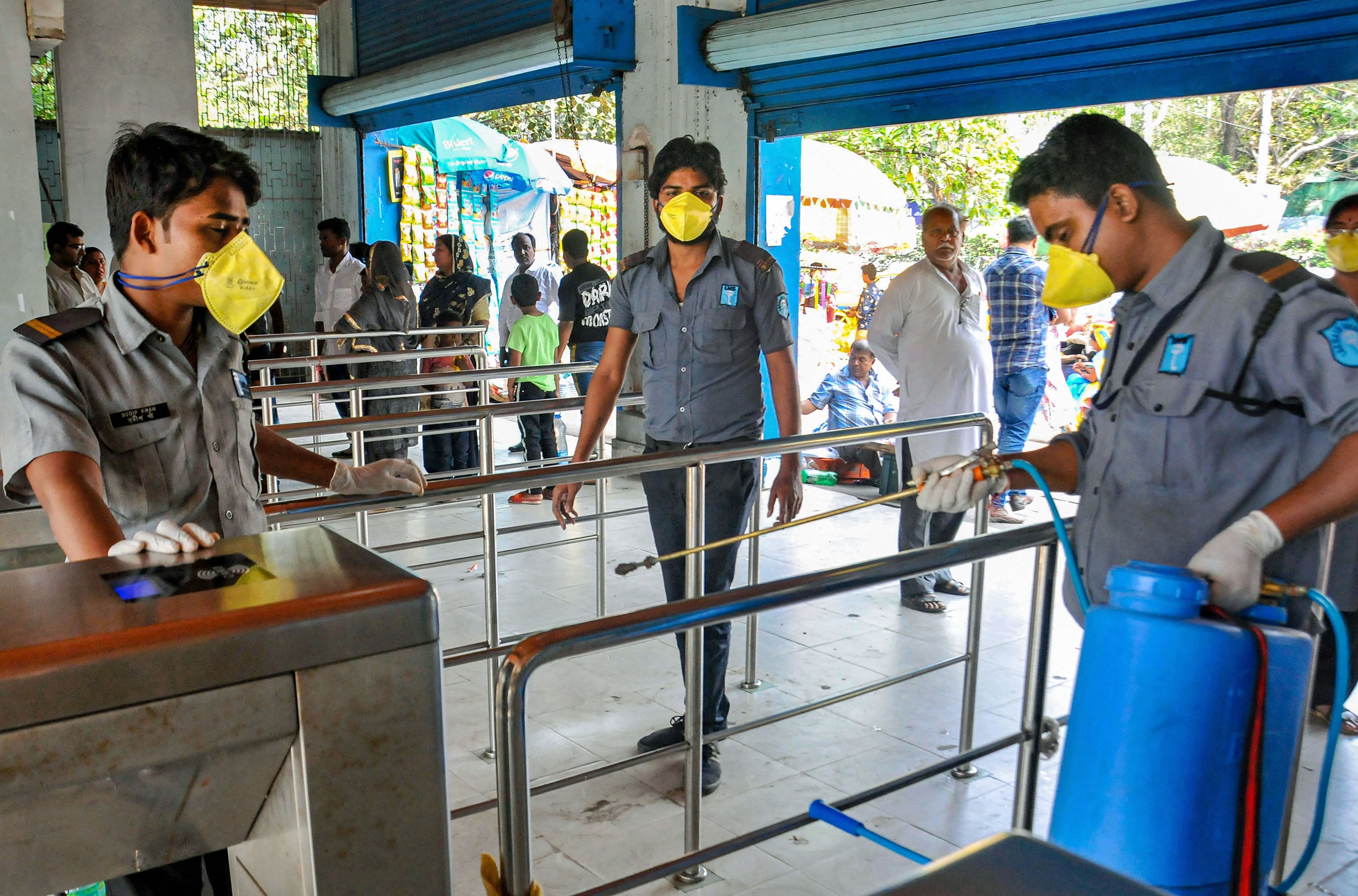 Kolkata: Cleaning staff members spray disinfectant on railings in the wake of deadly coronavirus, at the entrance gate of Alipore Zoological Garden. (Credit: PTI)
