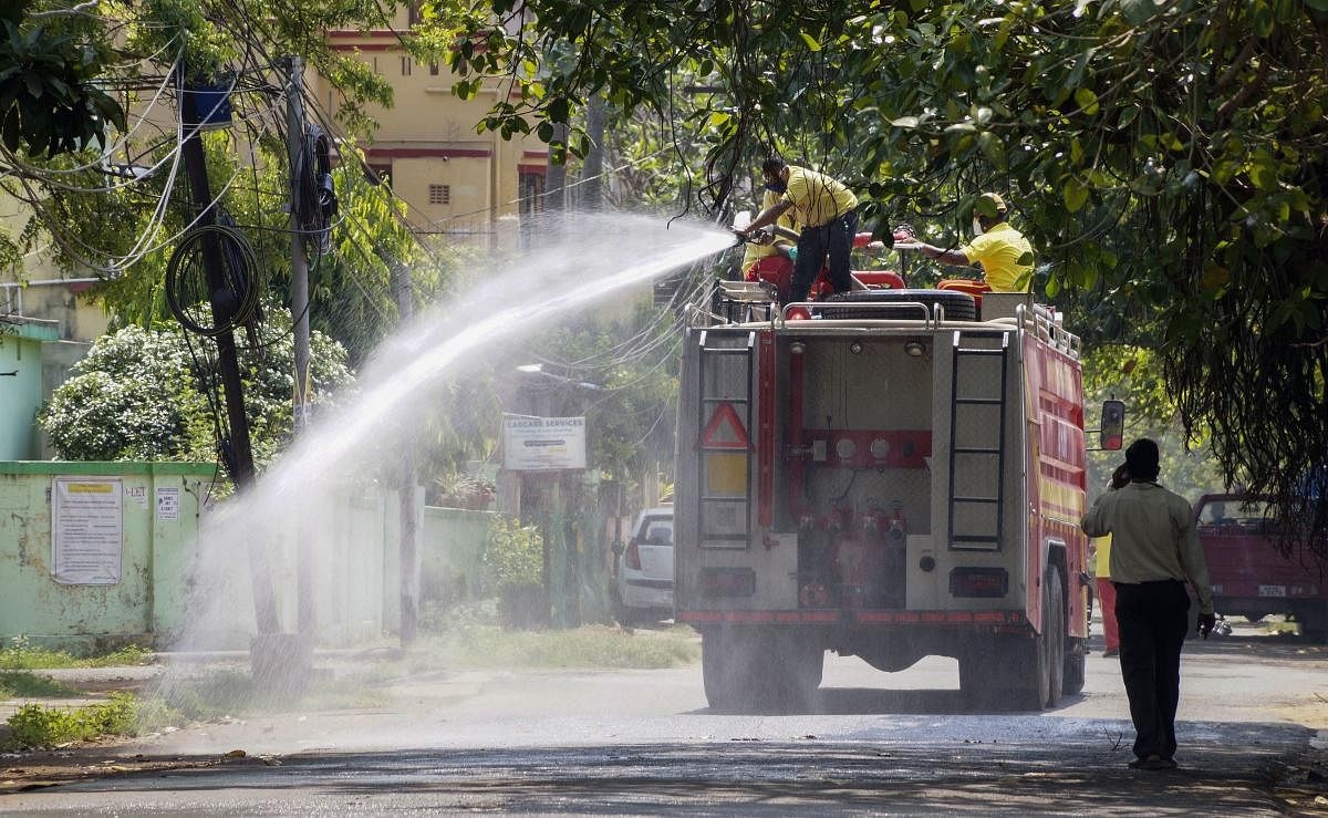  Firefighters spray disinfectant on a street during a nationwide lockdown in the wake of the coronavirus pandemic, at Surya Nagar in Bhubaneswar, Friday, April 3, 2020. (PTI Photo)