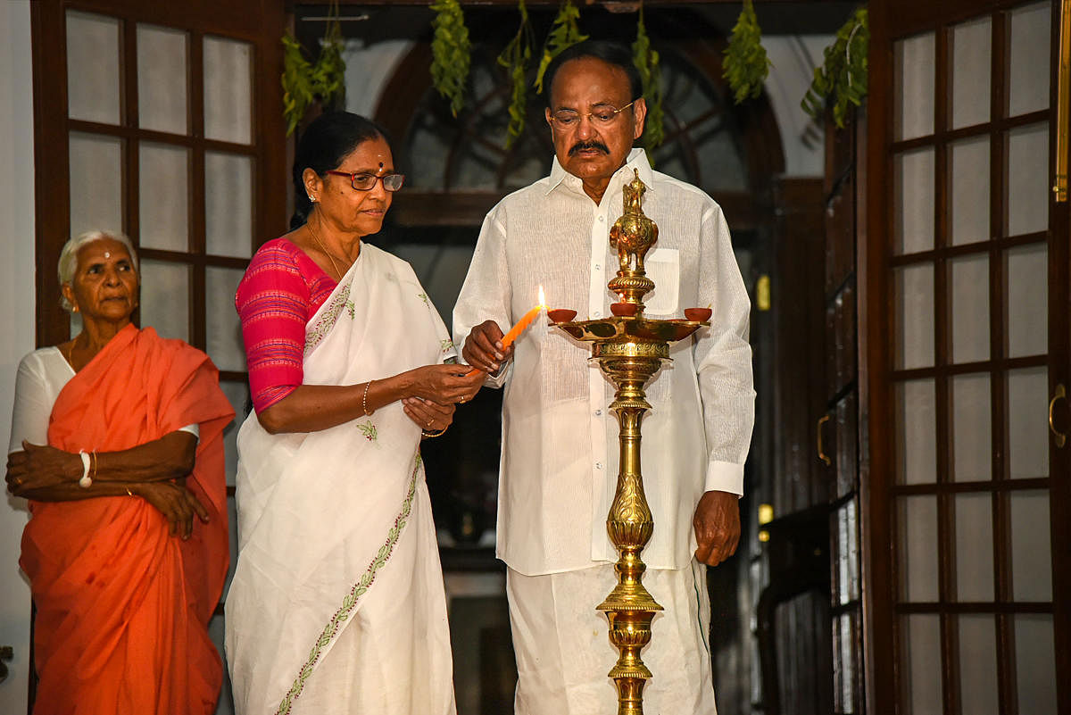 Vice President M.Venkaiah Naidu along with his wife Usha Naidu lights lamps amid the ongoing nationwide lockdown in the wake of coronavirus pandemic. PTI